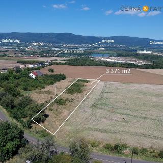 Prodej stavební parcely 3 371 m² Modlany